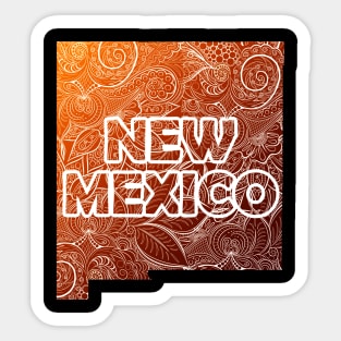 Colorful mandala art map of New Mexico with text in brown and orange Sticker